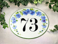 Oval ceramic house number plaque hand painted with blue cornflower and green border, custom address sign for outdoor