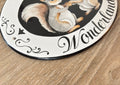 Oval decorative House plaque hand-painted with a squirrel and 'Wonderland' text on a wooden surface
