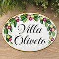 Oval ceramic house sign hand painted with olives and green leaves, personalized with name. 