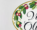 Detail of a ceramic house plaque hand painted with olives branches