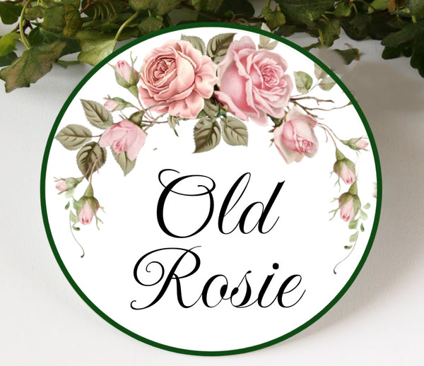 Round ceramic plaque hand-painted with pink roses and green leaves with the text Old Rosie