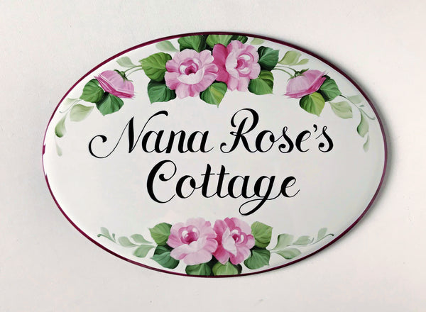 oval ceramic name sign hand-painted with pink roses and green leaves
