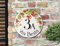 house number sign for front door hand painted with red berries on round ceramic plaque