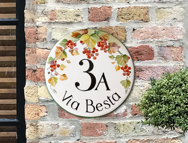 house number sign for front door hand painted with red berries on round ceramic plaque