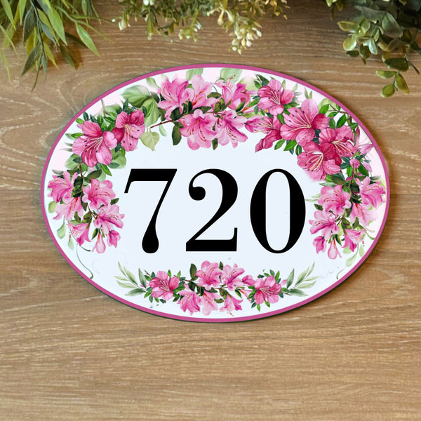 Decorative house number plate with pink Azaleas flowers and green leaves 