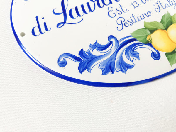 cloe-up border detail of a ceramic house sign hand painted with lemon 