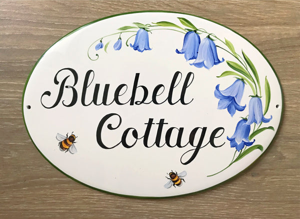 oval ceramic house sign with name, hand painted with blue bluebells and bees, outdoor welcome sign for cottage