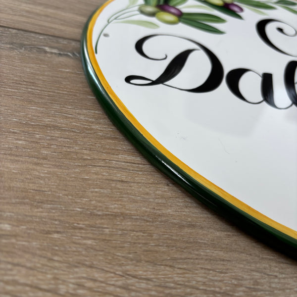 Border detail of a hand-painted ceramic house plaque