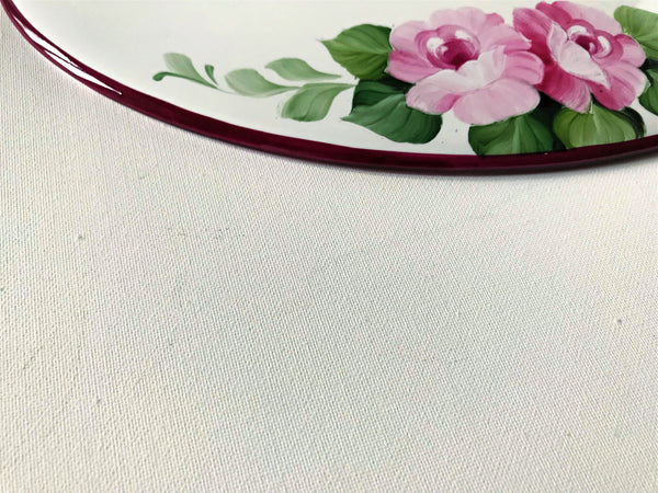 colse-up of a house sign border hand-painted in burgundy color