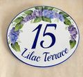 Oval ceramic address Plaque hand-painted with purple and blue Lilacs and green leaves