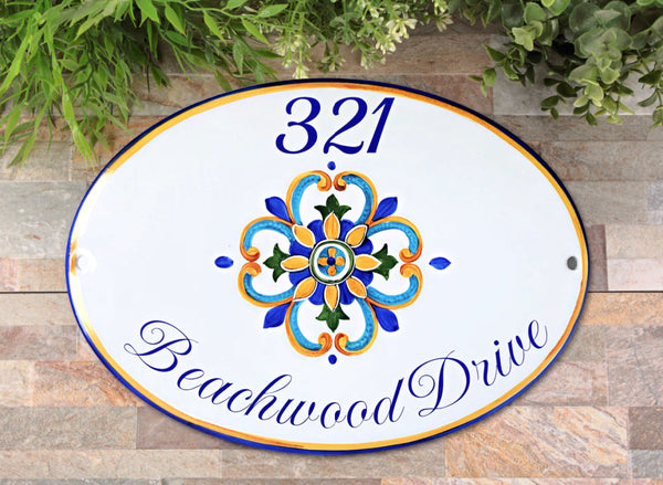 Ceramic oval house number plaque hand-painted with a mediterranean motive in blue and yellow colors, outdoor house sign