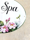 detail decoration of a ceramic house plaque hand-painted with pink lotus