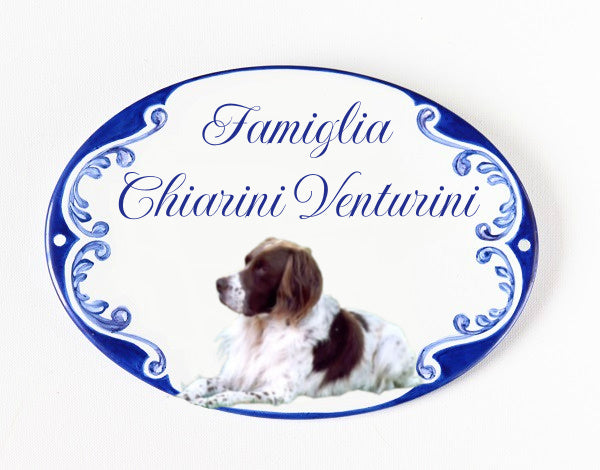 ceramic family name sign with a hand painted dog and a blue decoration, personalized with family names