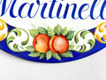 Decorative ceramic plaque hand-painted with peaches, leaves, on a blue background
