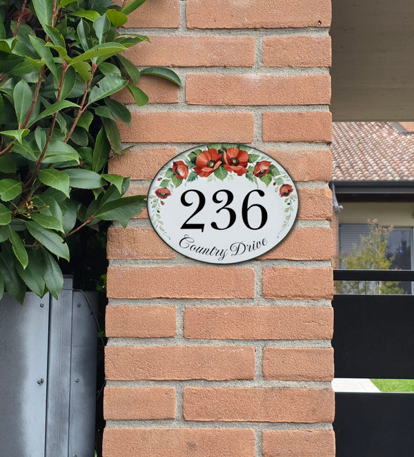 Ceramic Address Plaque hand-painted with red poppies, mounted on a brick wall