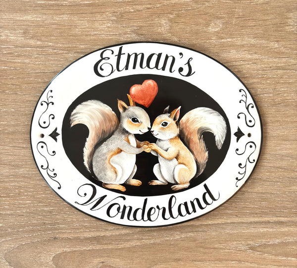Oval Ceramic House sign hand-painted with two squirrels holding a heart and 'Etman's Wonderland' text 
