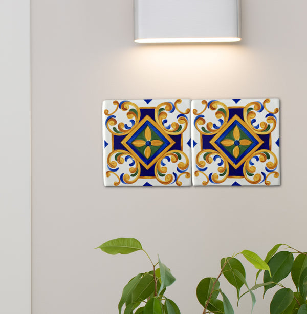 Hand-painted Talavera ceramic tiles in blue, green, and gold, mounted on outdoor wall, under entry light, for patio or front door décor.