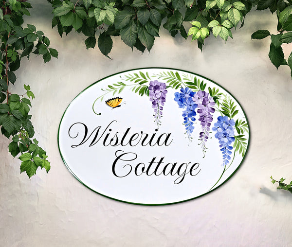 Welcome sign for front door hand painted with wisteria flowers and a yellow butterfly, oval ceramic plaque