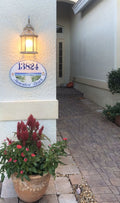 ceramic house number hand-painted with an ocean view mounted on a front door