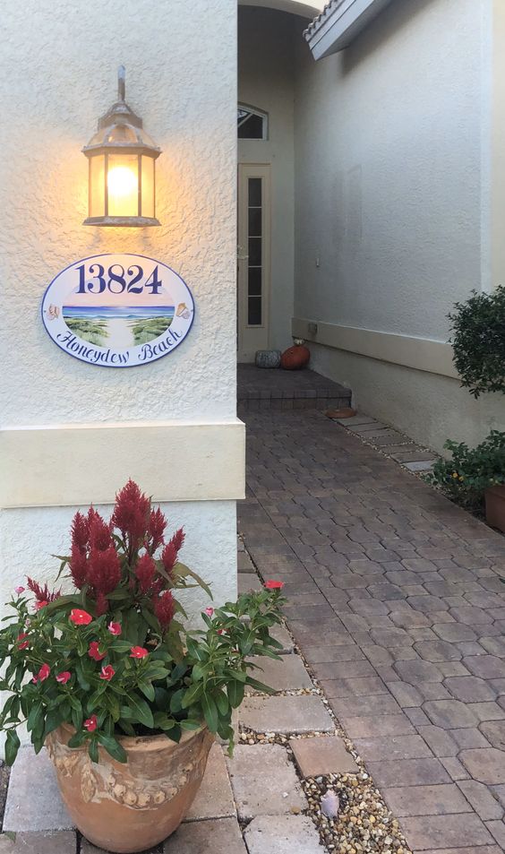 ceramic house number hand-painted with an ocean view mounted on a front door