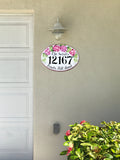 ceramic house number sign hand-painted with pink hydrangea mounted on a wall