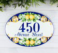 ceramic house number hand -painted with lemon and green leaves on a blue background