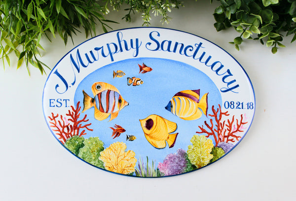 oval house name sign with colorful fishes